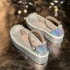 Gros plan de chaussures Mary Jane en maille argentée avec détails irisés et fleurs décoratives
