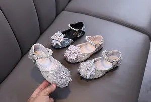 Detailed view of sparkling girls' princess Mary Jane shoes with rhinestones and pearls