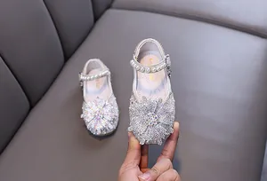 Detailed view of girls' sparkling rhinestone princess shoes featuring elegant pearl straps