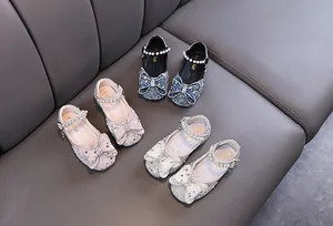 Overview of three colors of girls' princess shoes with rhinestone bows and pearl ankle straps
