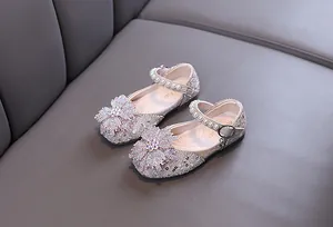 Detailed view of girls' princess shoes with sparkling rhinestones and pearl straps