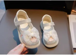 Detailed view of girls' white Hanfu shoes with pink embroidery and lace bow details