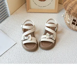 Top view of cream girls princess sandals featuring elegant crystal bow details and brown insoles