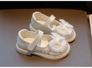 Detail view of white Hanfu embroidered girl's shoes with large mesh bows and floral patterns