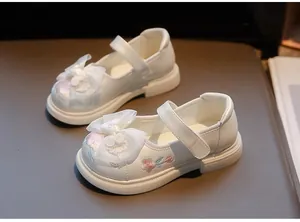 Detailed view of white Hanfu shoes for girls with floral embroidery and mesh bow