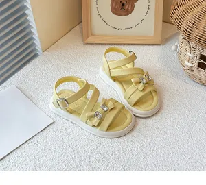Summer yellow girl's princess sandals with decorative rhinestone bows and cross-straps