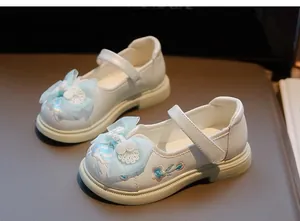 Close-up detail of white Chinese style embroidered princess shoes for girls with bows