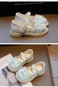 Detailed view of white Chinese style embroidered Hanfu shoes for girls with blue mesh bows.