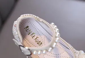 Detail of girls princess shoes featuring white pearls and sparkling rhinestone trim