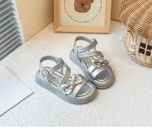 Detailed view of silver girls princess sandals featuring a sparkling rhinestone bow