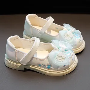 White Chinese style Hanfu shoes for girls with blue bow and embroidery detail