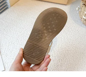 Close-up of anti-slip textured brown sole for girls princess sandals size 28