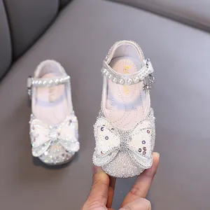 Elegant white sequined princess shoes for girls with large bow and pearl strap detail
