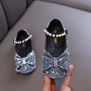 Elegant rhinestone-studded princess shoes for girls with pearl strap and bow decoration.