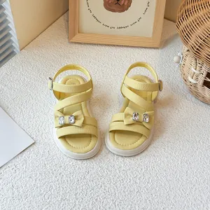 Stylish yellow girls' princess sandals with bow tie and rhinestone accents for summer.