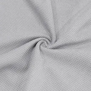 Close-up detail of light gray waffle knit fabric texture for men's casual summer polo shirt