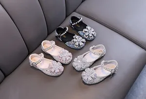 Detailed view of girls' rhinestone princess shoes in black, pink, and silver color