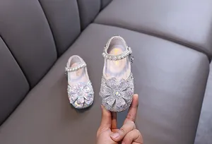 Sparkling rhinestone princess shoes for girls with large flower detail and pearl strap