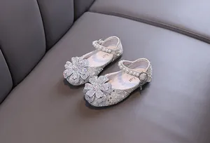 Close-up view of elegant girls princess dress shoes with rhinestones and pearls