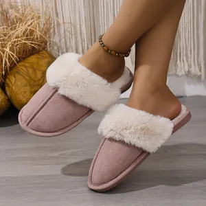 Detail view of stylish pink fuzzy home slippers with warm plush lining and soft suede finish