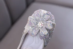 Detail showing close-up of sparkly rhinestone flower on girls' princess performance shoe
