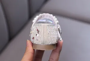 Macro detail of the sparkling rhinestone heel on these elegant girl's princess dance flats