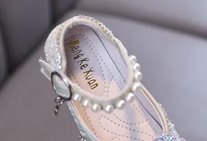 Detail shot of girls princess shoes with rhinestones, pearls and brand insole