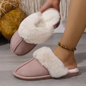 Detail showing soft white faux fur lining and pink suede exterior of winter home slippers