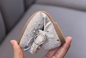 Macro view of flexible girls' princess shoes with sparkling rhinestones and pearls