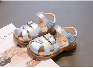 Silver closed-toe sandals for girls featuring decorative heart buckle and soft sole