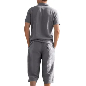 Back view of men's gray linen set with short sleeve polo shirt and cropped pants.