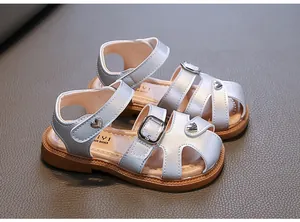 Silver girls' closed-toe sandals with heart buckle and soft brown sole
