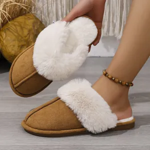 Detail view of cozy brown faux suede slippers with soft white fur lining for winter.