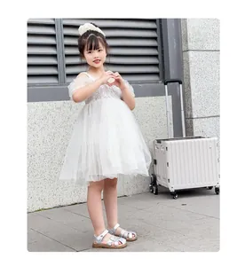 Close-up of a young girl wearing stylish silver closed-toe princess sandals outdoors.