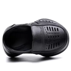 Top-down macro view of black leather breathable men's sandals with perforated details.