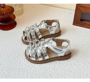 Detailed view of silver Lolita sandals for girls featuring elegant bow decorations