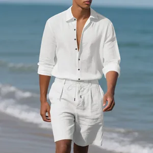 Man in white linen beach set walking along the ocean shore at daytime