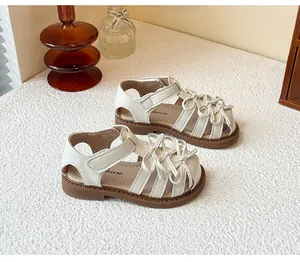 Elegant cream Lolita sandals for girls featuring multiple sweet bow-knots in a cozy setting