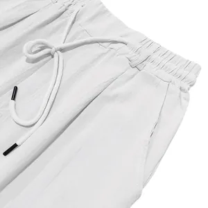 Close-up of white linen shorts waistband with adjustable drawstring and side pocket