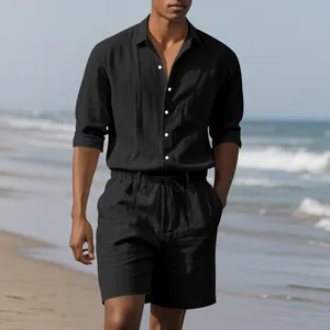 Men's black linen beach set featuring a long sleeve shirt and casual shorts on a coast.
