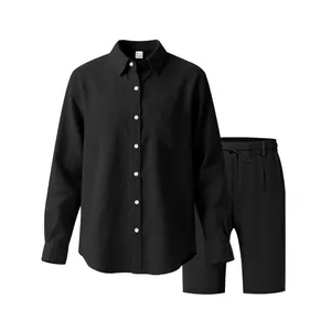 Detail view of black linen men's set featuring a long-sleeve shirt and matching shorts