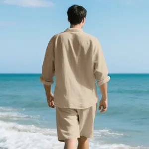 Back view of men's beige linen shirt and shorts set on a sunny summer beach scene