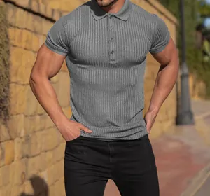 Men's grey short-sleeved ribbed polo shirt in slim fit, outdoor casual lifestyle view.