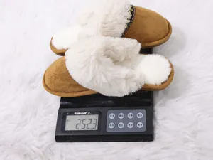 Close-up detail view showing the weight of brown faux fur slippers on a scale, 252.3g.