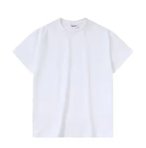 Détail d'un t-shirt blanc oversize à col rond avec design à épaules tombantes.
