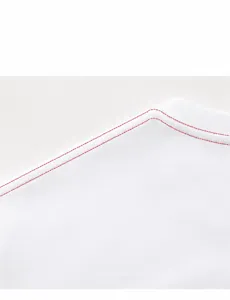 Close-up of durable reinforced shoulder seam with red stitching on a white t-shirt
