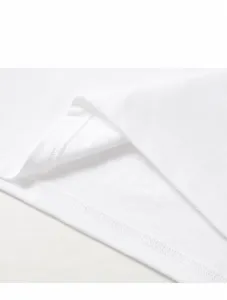 Detailed macro view showing the high-quality double-stitched hemline of a white cotton T-shirt