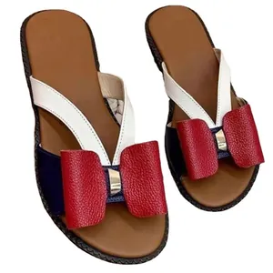 Stylish women's flat slides featuring a red leather bow and tricolor block straps