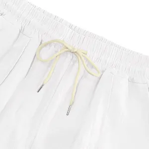 Close-up of elastic waistband with drawstring on white linen casual beach pants