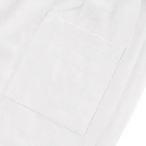 Close-up of the patch pocket on white breathable linen casual beach pants for men